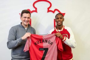 Junior Kuzanga with his new jersey and other team officials while signing as new team player for Southampton FC