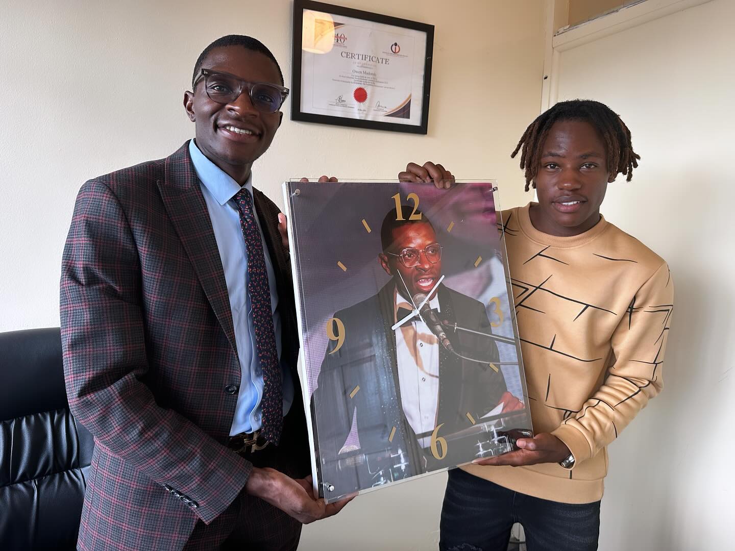 DJ Ollah with artist Nigel while receiving the portrait as gift