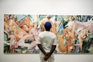 Photograph of a man looking at a painting at Cape Town Art Fair