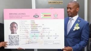 Minister Felix Mhona holding Plastic Driver's License
