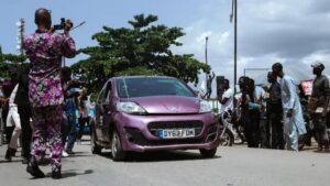 Pelumi Nubi with her purple Peugeot 107 