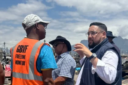 Councillor Carl Pophaim while examining the fire affected site in Cape Town