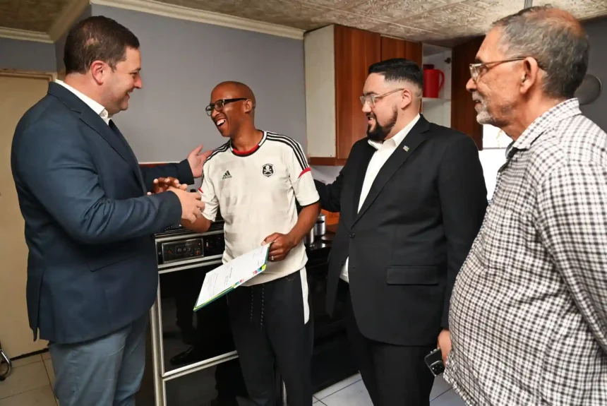 Mayor Geordin Hill-Lewis and Councillor Carl Pophaim with Title Deed recipients in Kalkfontein