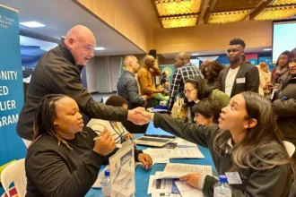 City of Cape Town's Alderman James Vos while shaking hands with Allison Hendricks from Clearer Conscience Environmental Services at a Smart Supplier match-up session in 2024