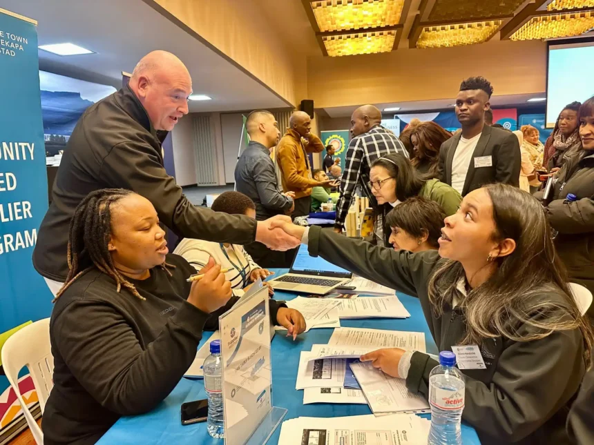 City of Cape Town's Alderman James Vos while shaking hands with Allison Hendricks from Clearer Conscience Environmental Services at a Smart Supplier match-up session in 2024