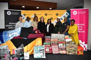 At the launch of the Winter Readiness Programme were from left Jean Ray Knighton Fitt (CEO of U-Turn Homeless Ministries), Shadrick Valayadum (CEO of The Haven Night Shelter), Bijou Bakole (COO from Elthios Centre), Councillor Francine Higham, Megan Pangeni (Community, Arts and Culture Department), Erefaan Jacobs (client at Oasis Reach for your dreams Safe Space), Perpetua Mamvura (Programme Co-ordinator at the Tygerberg Association for Street People), and Zodwa Mbontsi (CACD). In front on the bed is Ilse Maartens (Branch manager for Mould Empower Serve)