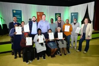 Mayor Geordin Hill-Lewis and Councillor Carl Pophaim with loyal tenants while recognising them in Cape Town