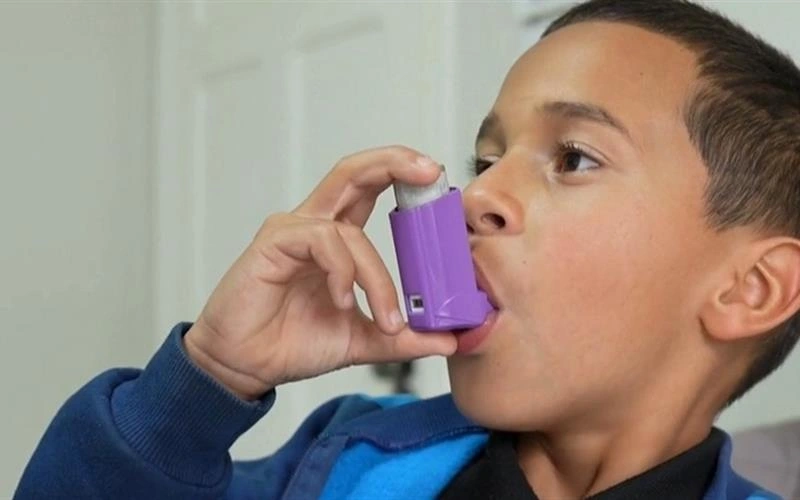 A child taking inhaler for Asthma