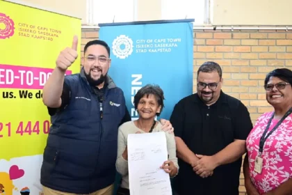 Councillor Carl Pophaim with a Macassar family Title Deed recipient in Cape Town