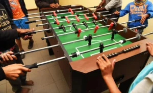 Young learners playing foosball at city library in Cape Town 