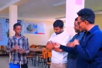 Ethiopian boy showing his invention to experts