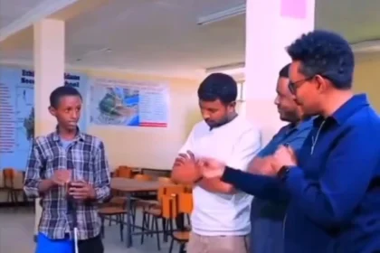 Ethiopian boy showing his invention to experts