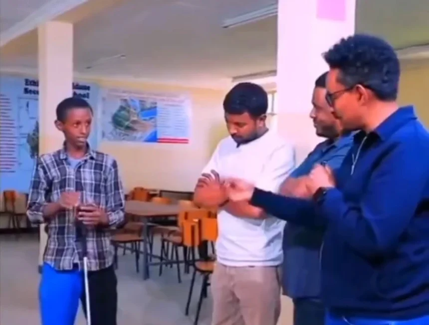 Ethiopian boy showing his invention to experts