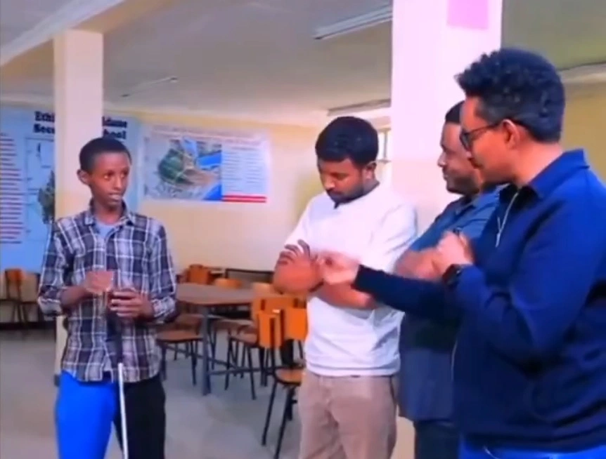 Ethiopian boy showing his invention to experts
