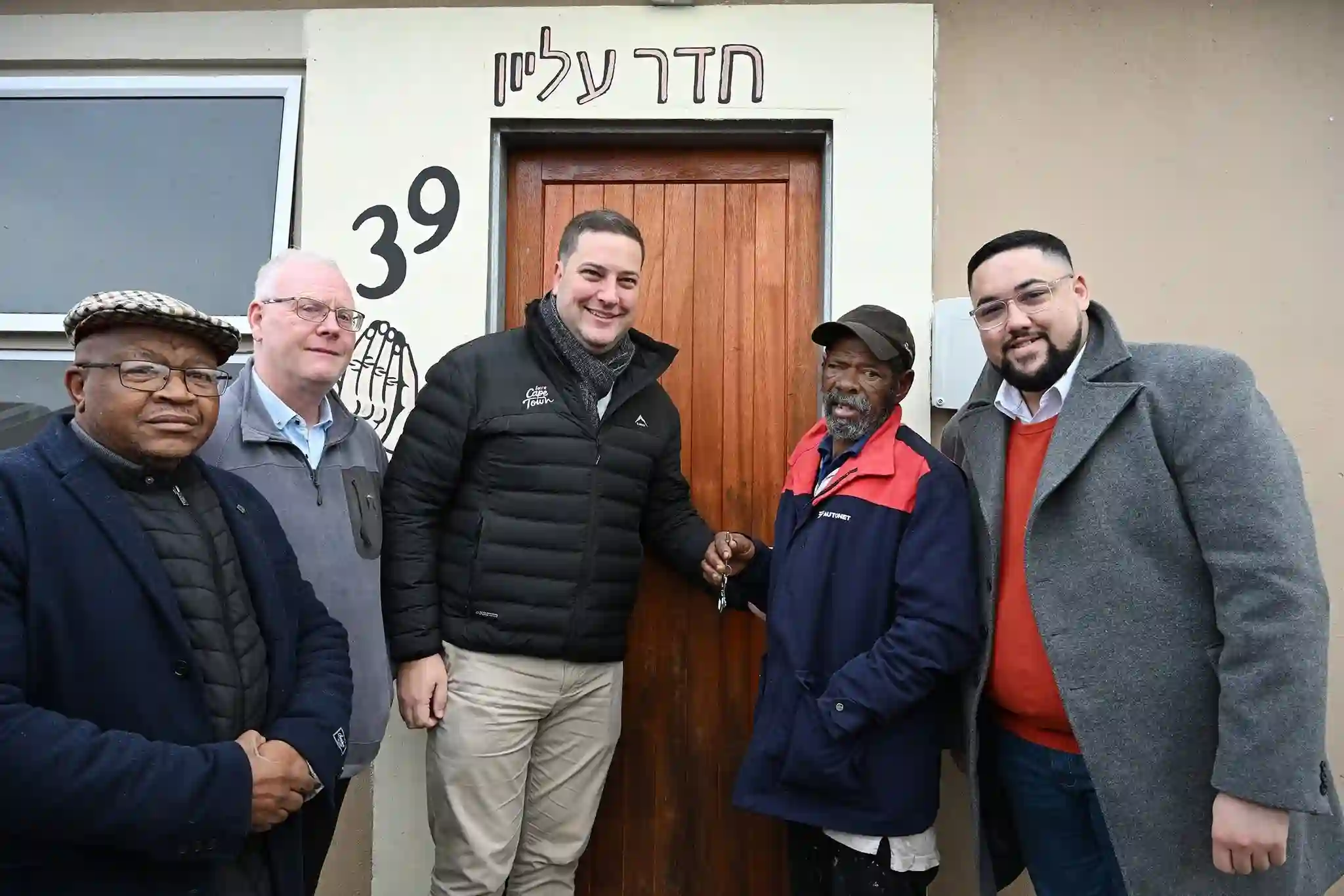 Mayor Geordin Hill-Lewis with Councillor Carl Pophaim handing over the Belhar Pentech House keys to the lawful beneficiary recipient in Cape Town
