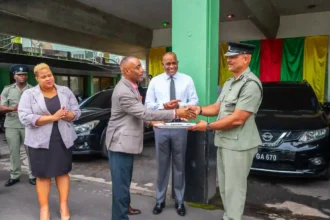 Prime Minister Roosevelt Skerrit and National Security Minister Rayburn Blackmoore while handing over the new vehicle to Chief Police in Dominica