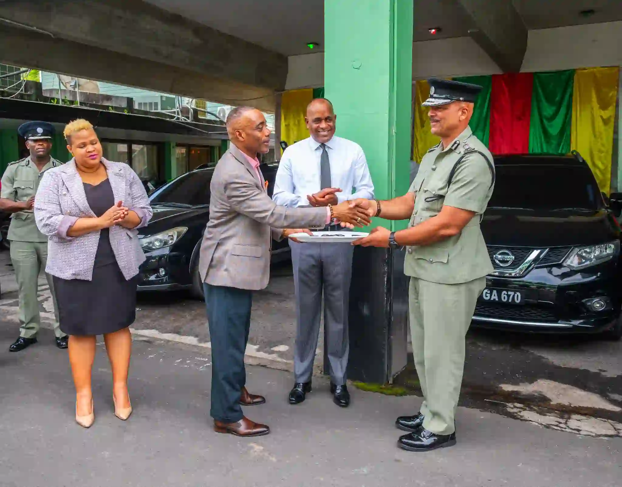 Prime Minister Roosevelt Skerrit and National Security Minister Rayburn Blackmoore while handing over the new vehicle to Chief Police in Dominica
