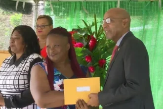 Acting PM Irving McIntyre handing over new home to Bellevue Chopin resident in Dominica
