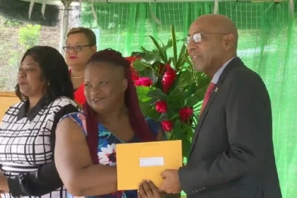 Acting PM Irving McIntyre handing over new home to Bellevue Chopin resident in Dominica