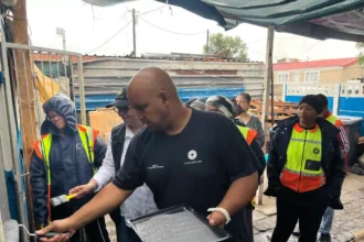Deputy Mayor Eddie Andrews with MURP and Atterbury team observing house painting project in Uitsig, Cape Town