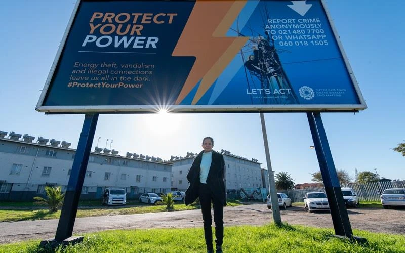 Alderman Xanthea Limberg, MMC for Energy, under the fixed streetlight to Protect Your Power campaign, Cape Town