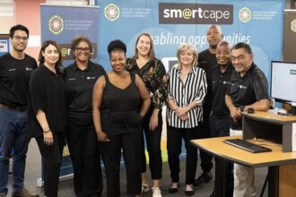 Cllr Francine Higham with Alderman Theresa Uys at SmartCape computer centre with their team in Cape Town