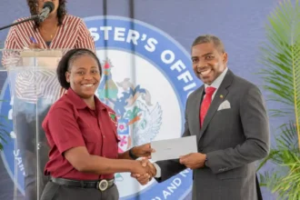 Prime Minister Dr. Terrance Drew distributing the new Digital Insurance Card to a Public Servant of St. Kitts and Nevis