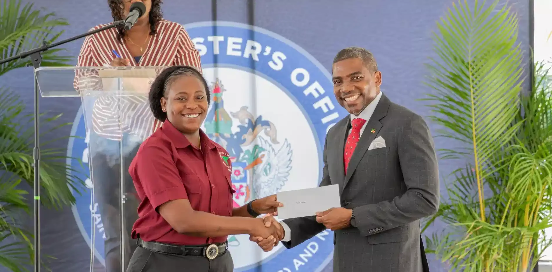Prime Minister Dr. Terrance Drew distributing the new Digital Insurance Card to a Public Servant of St. Kitts and Nevis
